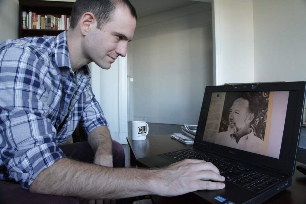 Jeff Ernsthausen looks at images of his uncle,  Richard Heyman. Photo credit: Paul Abowd
