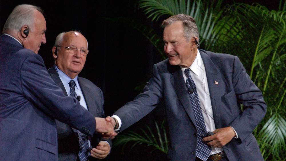 Former U.S. President George Bush, right, shakes the hand of Dr. Helmut Kohl, former Chancellor of the Federal Republic of Germany. In the middle is Mikhail S. Gorbachev, former President of the Union of Soviet Socialist Republics. The three former world leaders attended the Unification Conference in October 2003 at the Georgia World Congress Center. Photo: Joey Ivansco/AJC