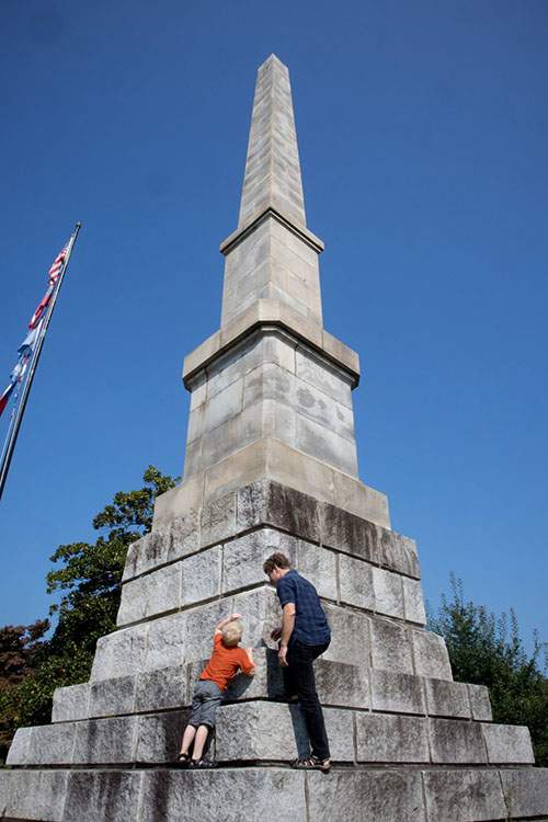 Father and son explore the Confederate Memorial Obelisk at Oakland Cemetery.