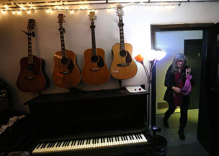 Caroline arrives at Vega Studios where she produces and hosts the New South Showcase, a live performance music show on WUGA, the local public radio station.