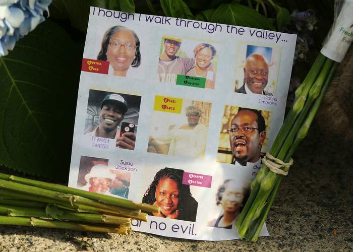 A sidewalk memorial includes photos of the 9 who were killed at the "Mother" Emanuel A.M.E. Church in Charleston, S.C. Curtis Compton \/ ccompton@ajc.com