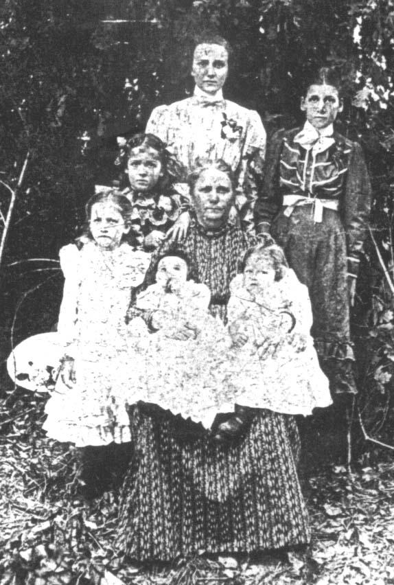 Mary Phagan's mother, Fannie Phagan Coleman (center), with her family in Atlanta, 1902. She holds Mary (right) and another child. Mary Phagan's older sister, Ollie Mae, stands at front left.PHOTO: The William Breman Jewish Heritage Museum