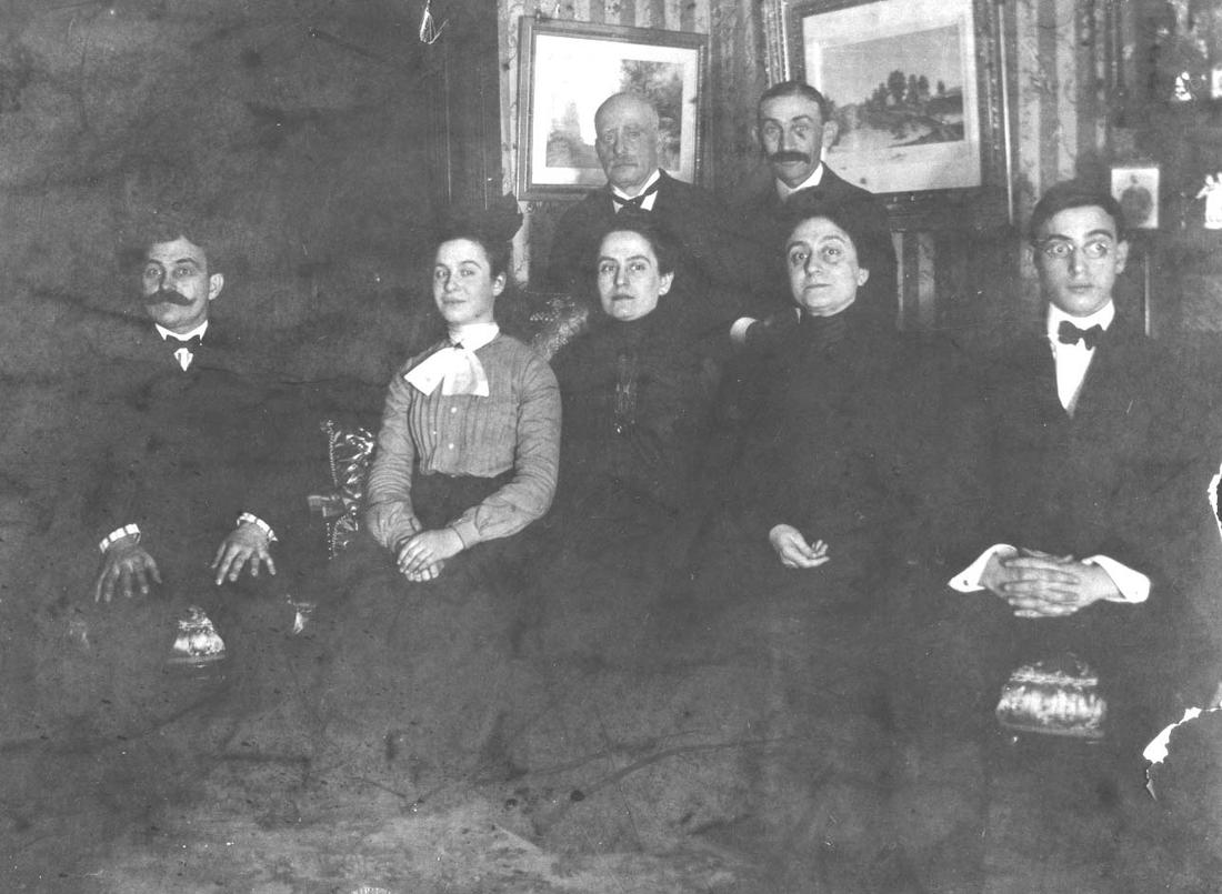 Marian Frank (in white scarf) and brother Leo (far right) sit for a family portrait with their aunts and uncles.PHOTO: The William Breman Jewish Heritage Museum